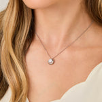 Load image into Gallery viewer, A sterling silver circle necklace with a cubic zirconia set twist feature on a chain.-JOOLS by Jenny Brown
