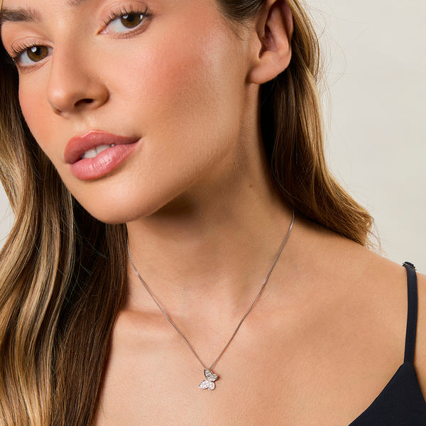 A sterling silver necklace with a small pave set butterfly pendant made of cubic zirconia stones-JOOLS by Jenny Brown