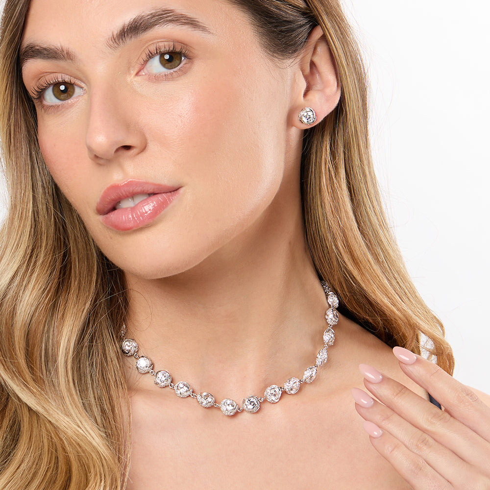 A sterling silver necklace with a twisted chain design and round cubic zirconia stones set in a pave setting.