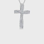 Load and play video in Gallery viewer, A sterling silver twisted cross pendant pave set with  white cubic zirconia stones, accompanied by a silver curb chain.
