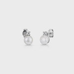 Load and play video in Gallery viewer, A pair of sterling silver stud earrings featuring a freshwater pearl with a cubic zirconia bale-JOOLS by Jenny Brown
