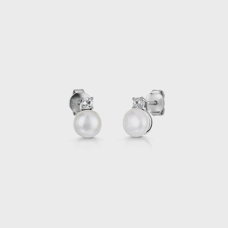 A pair of sterling silver stud earrings featuring a freshwater pearl with a cubic zirconia bale-JOOLS by Jenny Brown