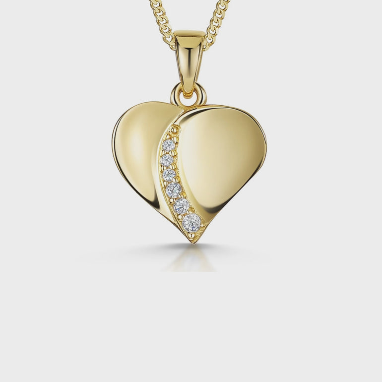 A yellow gold heart-shaped pendant with a line of cubic zirconia stones on it-JOOLS by Jenny Brown