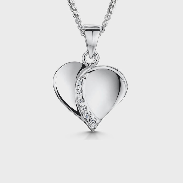 A sterling silver polished heart pendant with a cubic zirconia stone in the center-JOOLS by Jenny Brown