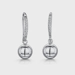 Load and play video in Gallery viewer, A pair of sterling silver fishhook earrings featuring a plain silver ball drop with pave set cubic zirconia stones
