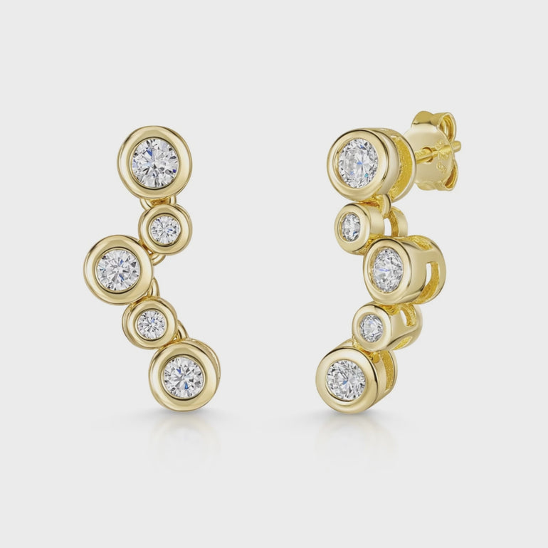 A pair of yellow gold bubble drop earrings with five cubic zirconia stones, featuring a series of increasing sizes of stones set in a curved design.
