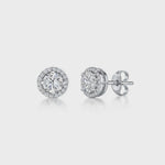 Load and play video in Gallery viewer, A pair of sterling silver halo style stud earrings with a central cubic zirconia stone surrounded by smaller cubic zirconia stones, rhodium finished-JOOLS by Jenny Brown
