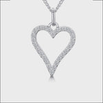 Load and play video in Gallery viewer, A sterling silver open pave heart pendant with a cubic zirconia surround on a chain.
