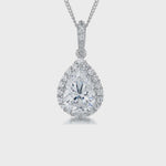 Load and play video in Gallery viewer, Solid 925 sterling silver necklace with a large pear-cut white cubic zirconia center stone and a pavé halo pendant on a silver chain.
