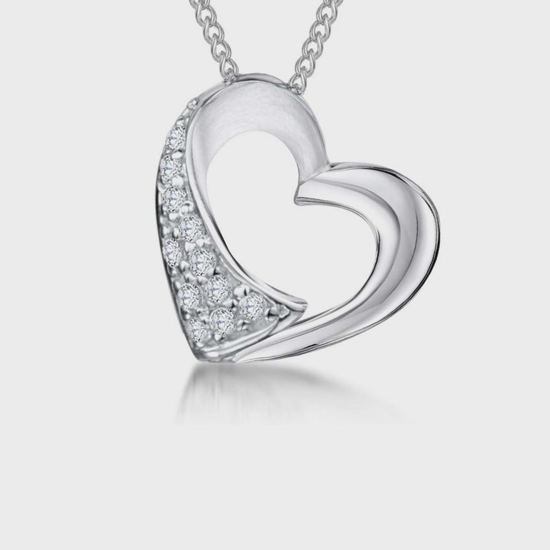 A sterling silver heart-shaped pendant with polished and satin finishes, adorned with offset cubic zirconias, displayed on a chain.