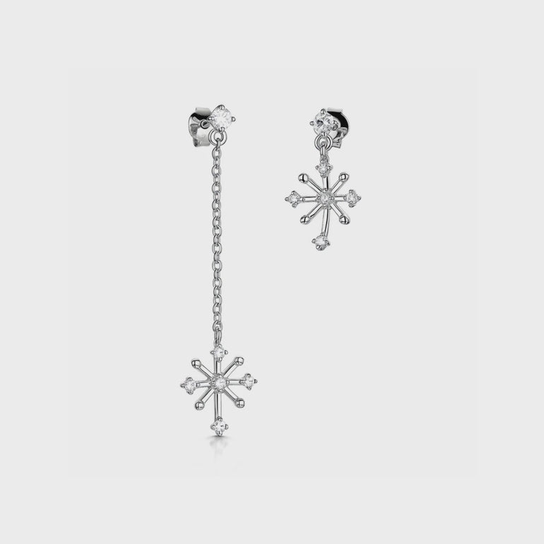 A pair of sterling silver snowflake earrings with cubic zirconia stones, one earring longer than the other, JOOLS by Jenny Brown