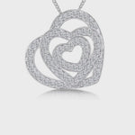Load and play video in Gallery viewer, A sterling silver pendant with three interlocking hearts, each studded with cubic zirconia stones - JOOLS By Jenny Brown
