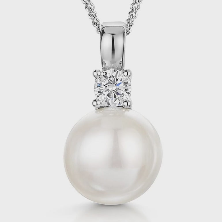  Large 9mm white round freshwater pearl pendant with a sparkling cubic zirconia accent in a sterling silver setting