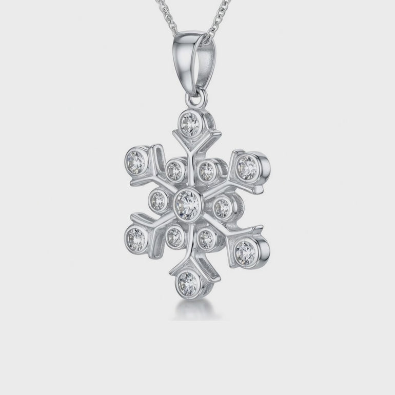 video clip of A sterling silver pendant in the shape of a snowflake, adorned with round cubic zirconia stones,-JOOLS by Jenny Brown