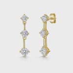 Load and play video in Gallery viewer, A pair of yellow gold drop earrings featuring three cubic zirconia stones of different sizes-JOOLS by Jenny Brown
