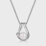Load and play video in Gallery viewer, 925 sterling silver teardrop pendant necklace featuring a round white freshwater pearl and sparkling pavé cubic zirconia accents.
