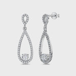 Load and play video in Gallery viewer, A pair of sterling silver teardrop earrings with a single cubic zirconia stone in the center, surrounded by smaller pave-set cubic zirconia stones.-JOOLS by Jenny Brown
