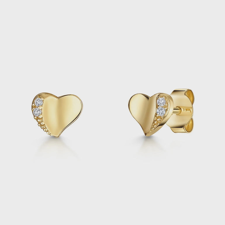 A pair of yellow gold offset heart stud earrings  edged with two with cubic zirconia stones,-JOOLS by Jenny Brown