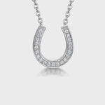 Load and play video in Gallery viewer, A sterling silver horseshoe pendant necklace with cubic zirconia stones set in a fixed chain-JOOLS by Jenny Brown
