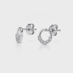 Load and play video in Gallery viewer, A pair of sterling silver circle earrings with white zirconia stones set in a half circle design.
