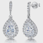 Load and play video in Gallery viewer, A pair of sterling silver pear drop halo earrings with cubic zirconia centers-JOOLS by Jenny Brown
