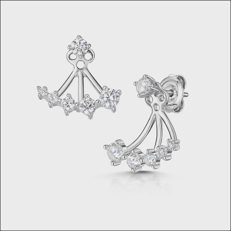 A pair of sterling silver jacket earrings featuring a solitaire stud and a row of graduated cubic zirconia stones.