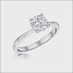 Load and play video in Gallery viewer, A sterling silver round brilliant solitaire ring with a single 1.5 carat cubic zirconia stone set in a four-prong  setting- JOOLS by Jenny Brown
