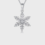 Load and play video in Gallery viewer, Sterling silver snowflake pendant with clear cubic zirconia stones on a silver  chain.
