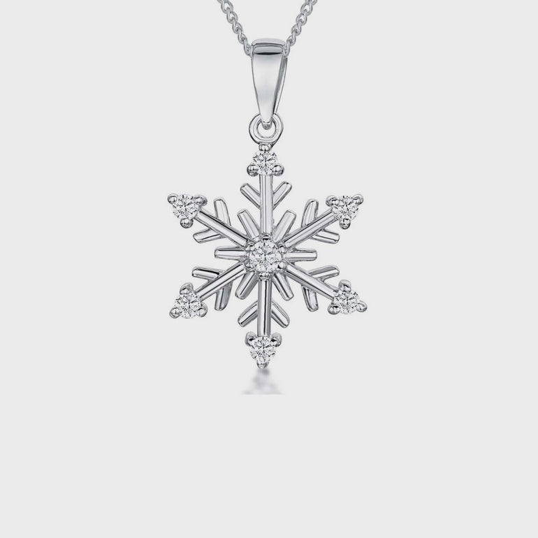 Sterling silver snowflake pendant with clear cubic zirconia stones on a silver  chain.