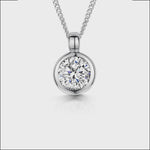 Load and play video in Gallery viewer, Solid 925 sterling silver round solitaire pendant with a brilliant-cut cubic zirconia in a bezel setting on a silver curb chain.

