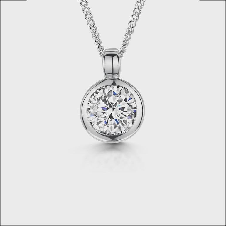 Solid 925 sterling silver round solitaire pendant with a brilliant-cut cubic zirconia in a bezel setting on a silver curb chain.