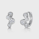 Load and play video in Gallery viewer, Pair of sterling silver huggie earrings featuring round clear cubic zirconia stones 

