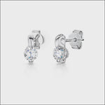 Load and play video in Gallery viewer, A pair of sterling silver stud earrings with a claw setting and cubic zirconia stones, displayed on a white background.
