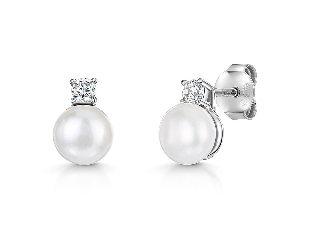 A pair of sterling silver stud earrings featuring a freshwater pearl with a cubic zirconia bale-JOOLS by Jenny Brown