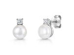 Load image into Gallery viewer, A pair of sterling silver stud earrings featuring a freshwater pearl with a cubic zirconia bale-JOOLS by Jenny Brown
