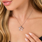 Load image into Gallery viewer, A sterling silver open star pendant set with cubic zirconias, attached to a chain.-JOOLS by Jenny Brown

