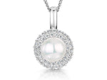 Load image into Gallery viewer, A sterling silver pendant with a central white freshwater pearl surrounded by a halo of cubic zirconia stones, on a silver chain-JOOLS by Jenny Brown
