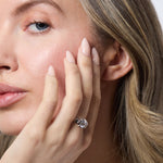 Load image into Gallery viewer, A sterling silver solitaire ring with an open setting featuring a round cubic zirconia stone.
