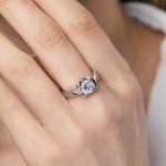 Load image into Gallery viewer, A sterling silver solitaire ring with an open setting featuring a round cubic zirconia stone.
