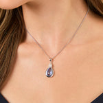 Load image into Gallery viewer, A sterling silver teardrop pendant with blue topaz and cubic zirconia accents, attached to a silver chain-JOOLS by Jenny Brown

