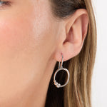 Load image into Gallery viewer, A pair of sterling silver circle earrings with offset  rubover cubic zirconia -JOOLS by Jeny Brown
