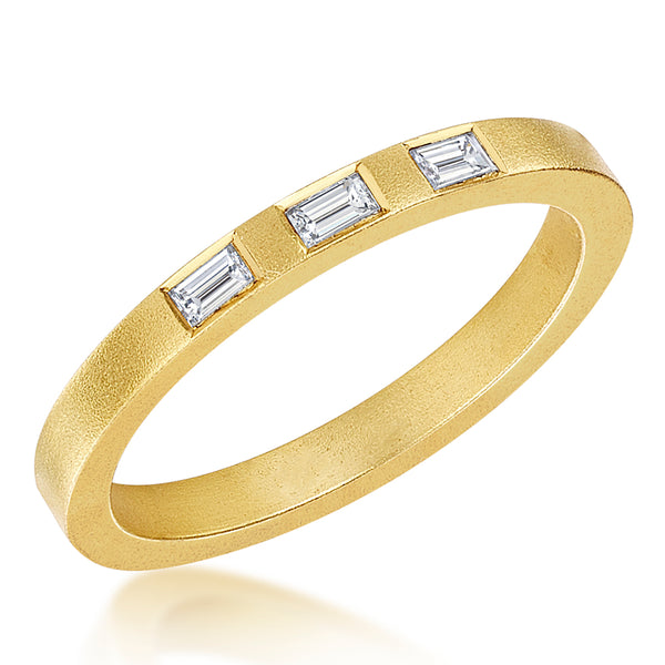 A yellow gold matte finish ring band with three baguette diamonds set on top.

