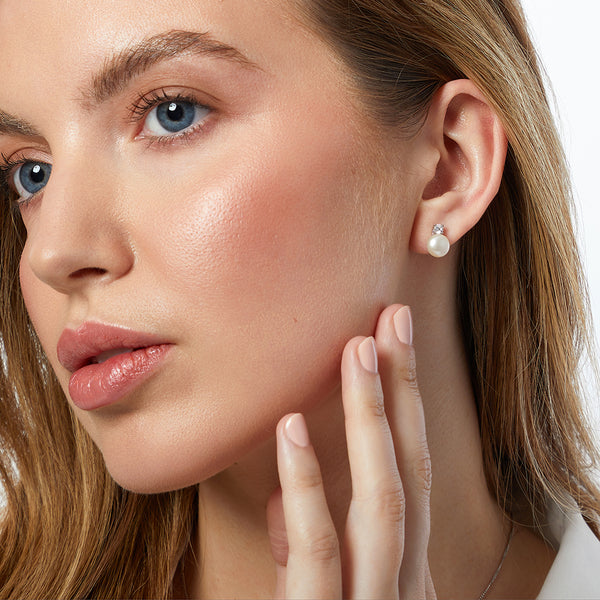 A pair of sterling silver stud earrings featuring a freshwater pearl with a cubic zirconia bale-JOOLS by Jenny Brown