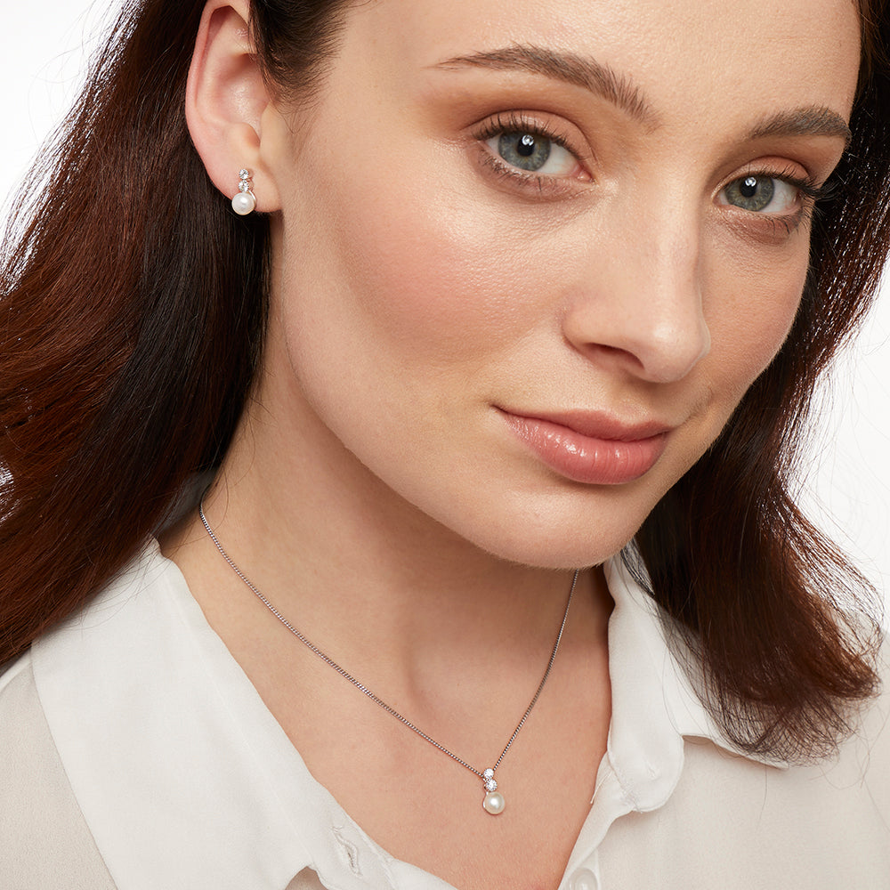 A sterling silver necklace with a freshwater pearl pendant and two white zirconia stones set in a rhodium finished chain-JOOLS by Jenny Brown