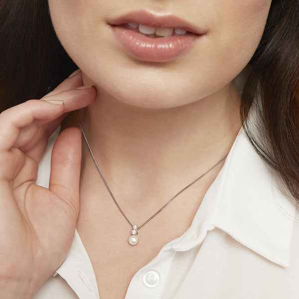 A sterling silver necklace with a freshwater pearl pendant and two white zirconia stones set in a rhodium finished chain-JOOLS by Jenny Brown