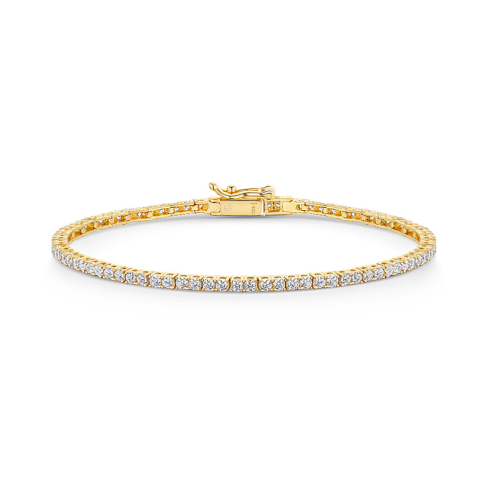A yellow gold 2mm cubic zirconia tennis bracelet with cubic zirconia stones, featuring a snap fastening- JOOLS By Jenny Brown