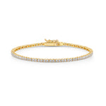 Load image into Gallery viewer, A yellow gold 2mm cubic zirconia tennis bracelet with cubic zirconia stones, featuring a snap fastening- JOOLS By Jenny Brown
