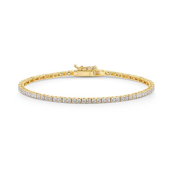 A yellow gold 2mm cubic zirconia tennis bracelet with cubic zirconia stones, featuring a snap fastening- JOOLS By Jenny Brown