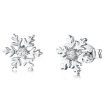 Load image into Gallery viewer, A pair of sterling silver snowflake earrings with a central cubic zirconia stone in each earring-JOOLS by Jenny Brown
