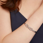 Load image into Gallery viewer, A sterling silver double knot cuff bangle with a high polished finish. - JOOLS By Jenny Brown
